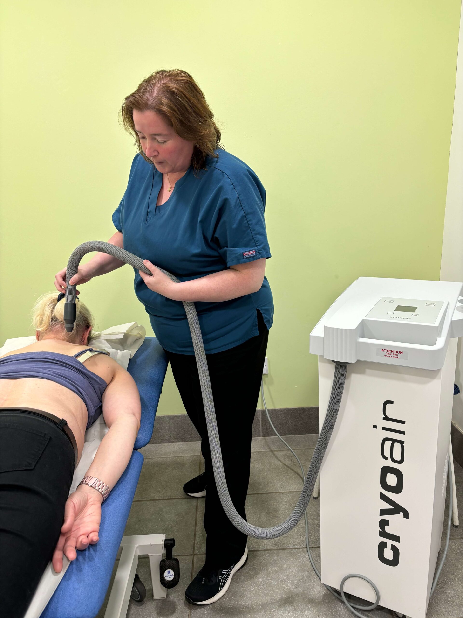 a lady lying down getting cryotherapy treatment